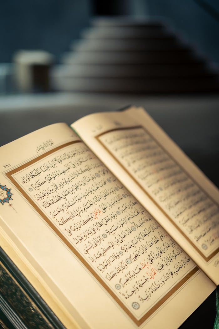 services-01 Close-up of an open Quran with Arabic script in a peaceful indoor setting.
