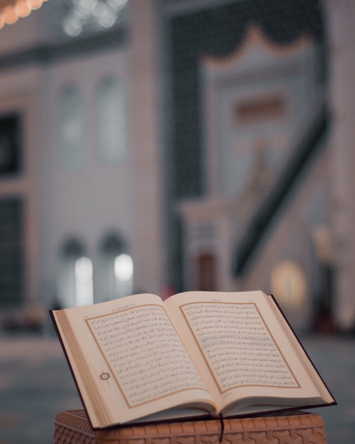 gallery-5 High angle of opened Koran book placed on stone stand in yard of ancient mosque